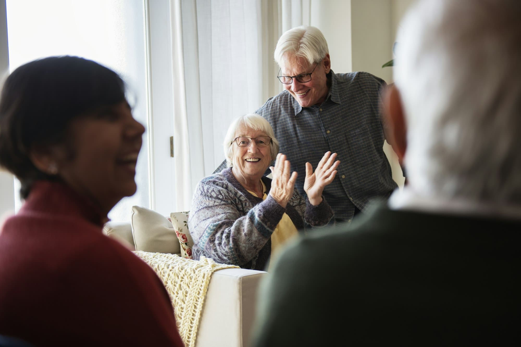 Senior people talking in a living room